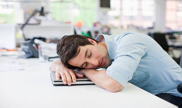 Businessman sleeping on laptop