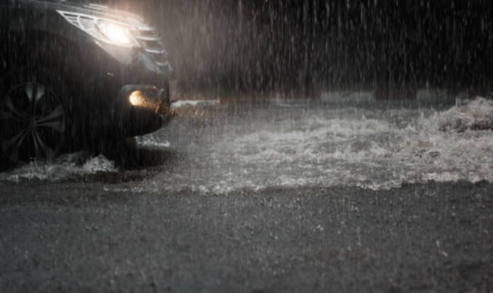 Heavy rain and car headlight on