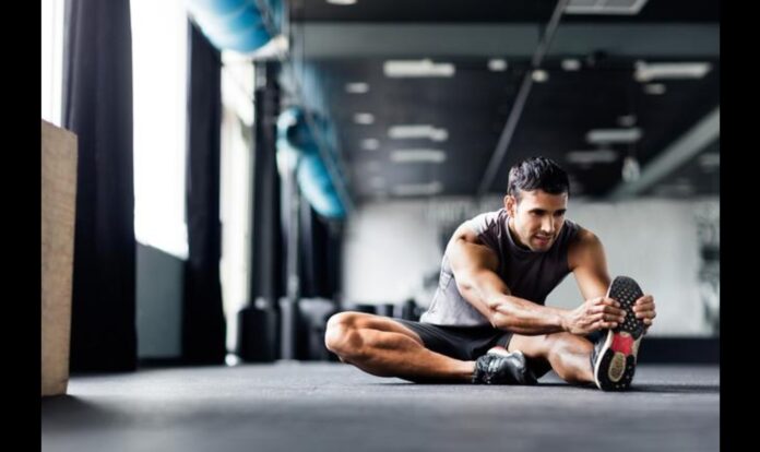 Men doing stretching at the gym