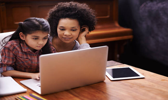 Mom and daughter using laptop