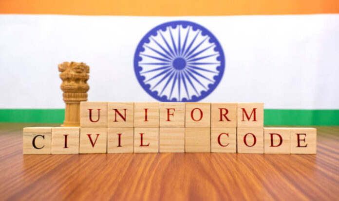 Uniform civil code written on blocks with pillars and Indian flag