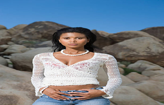 Woman standing by rocks