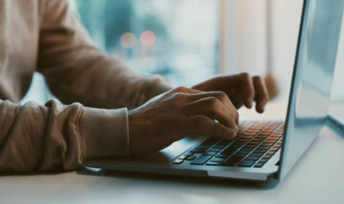 Hands on laptop keyboard