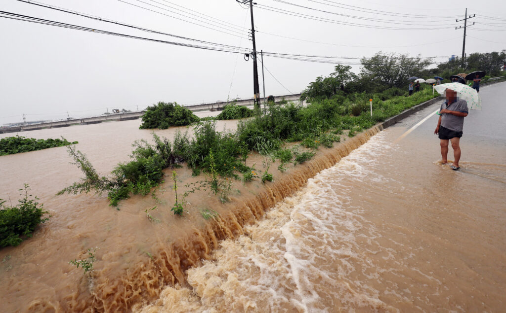 road submerged by a flooded river