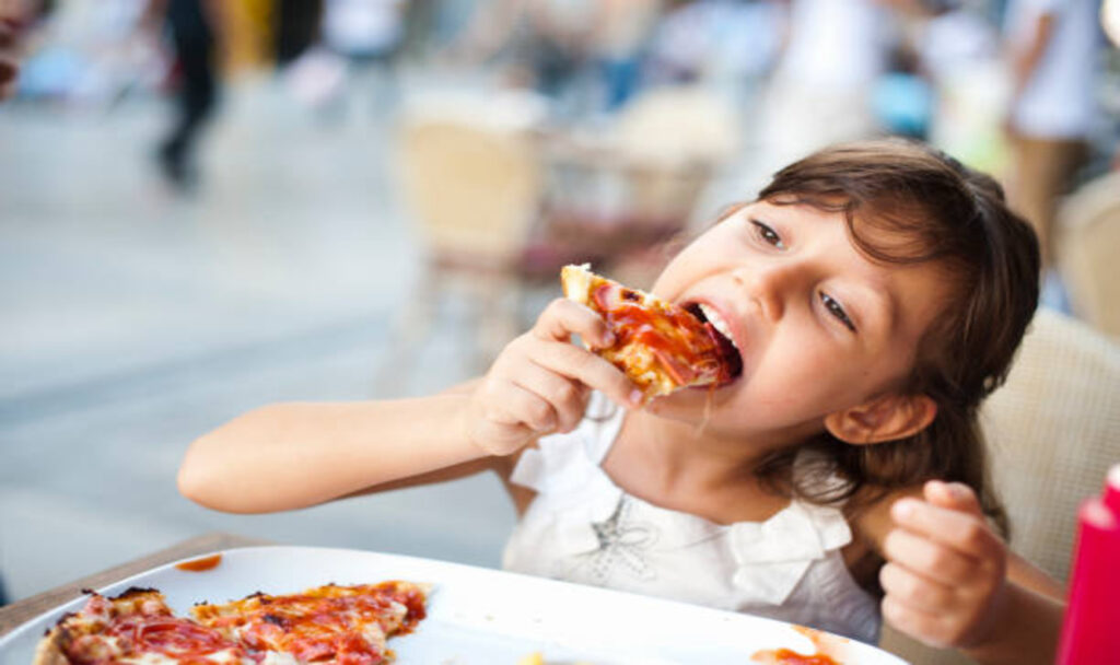 Girl enjoying pizza