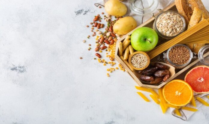 Healthy vegetables and nuts aside on white background