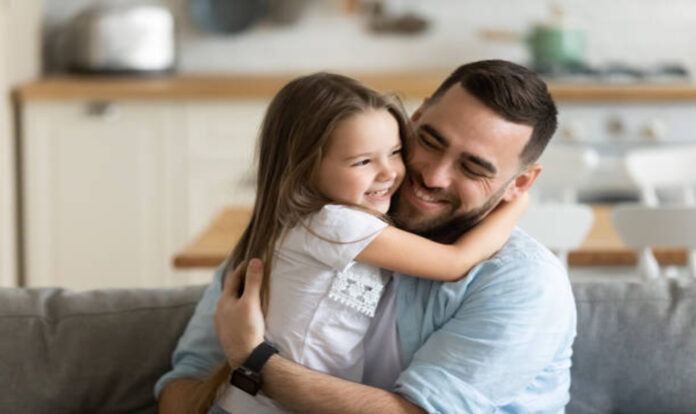 Father hugging little daughter