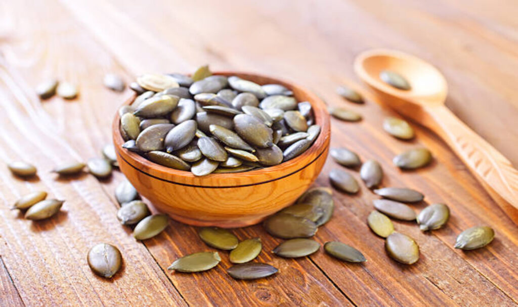 pumpkin-seed in bowl on wooden background