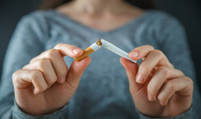 Woman breaking cigarette