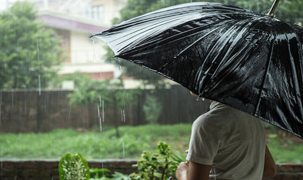 Boy holding umbrella outdoors