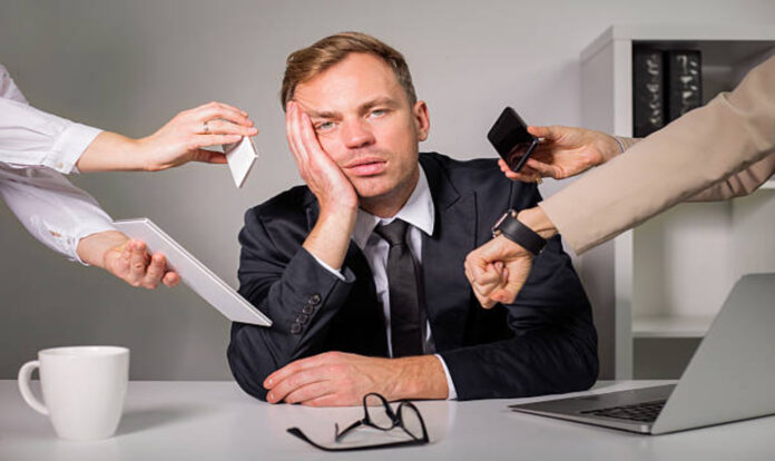 Tired man overloaded with work