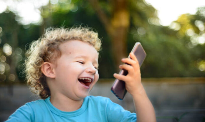 toddler-boy using phone