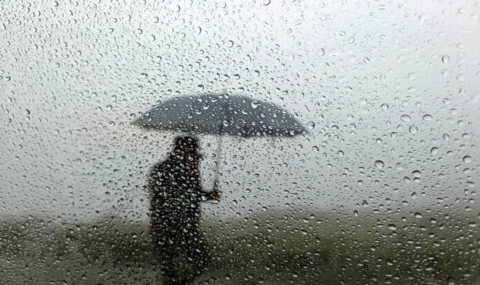 Rainwater-drops-on-the-glass and man walking