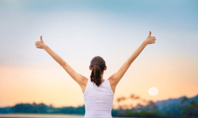 Backview of woman giving thumbs up