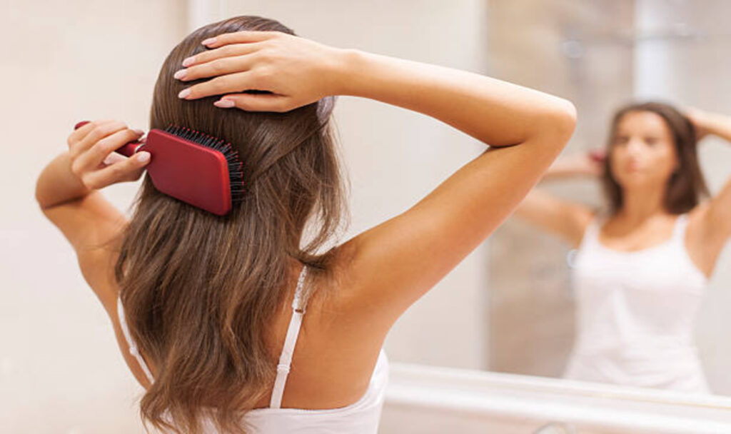 Woman combing her hair