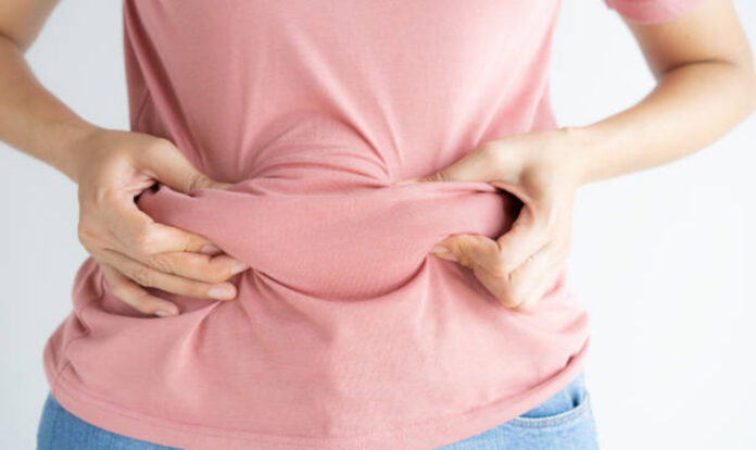 Woman holding belly fat