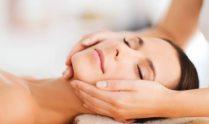 Woman having facial massage in spa