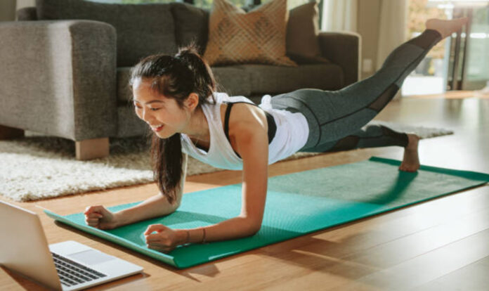 Woman doing exercises watching online