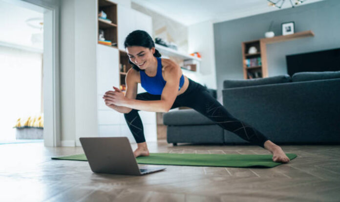 Woman exercising from laptop